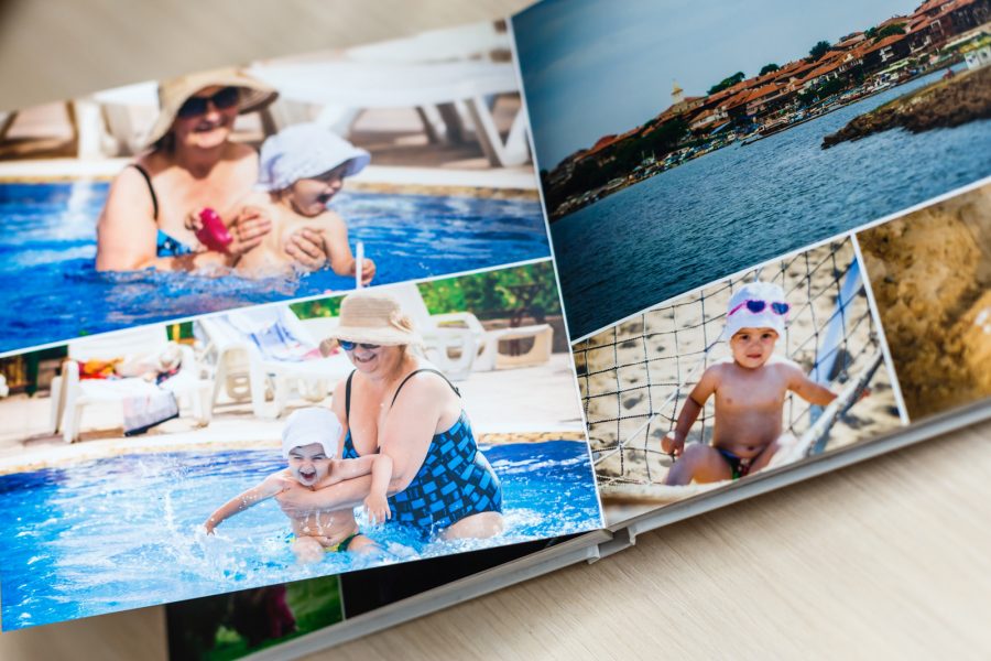 Photobook,Album,On,Deck,Table,With,Travel,Photos Photobook album on deck table with travel photos