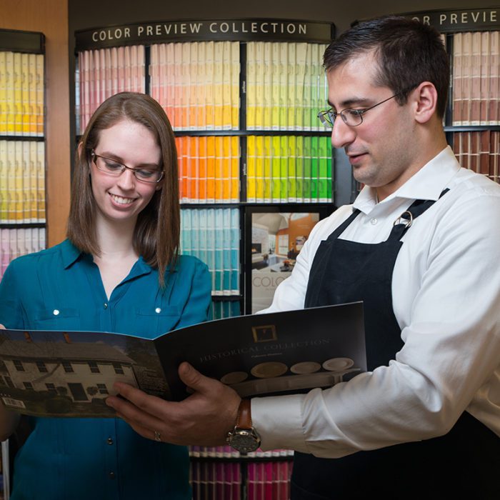 Color expert showing woman color catalogue