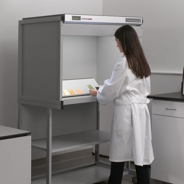 Lab technician working with a Datacolor Lightbooth for color evaluation.