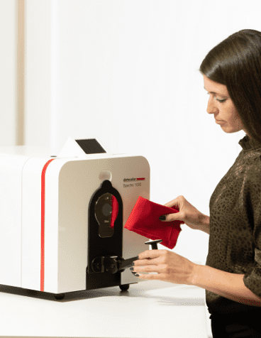 woman using spectrophotometer to measure fabric