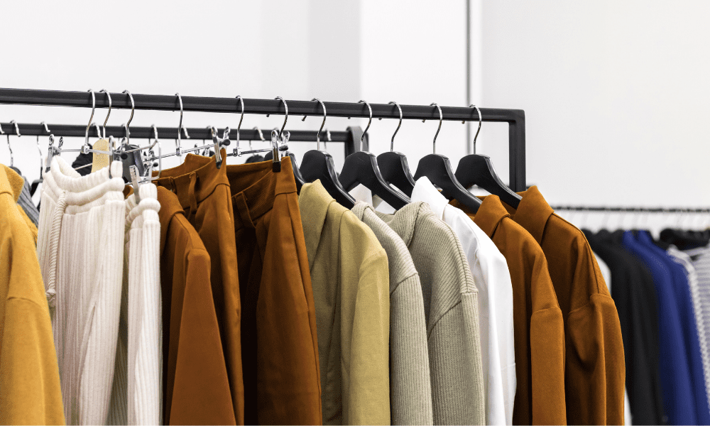 Brown shirts and pants displayed on rack in store