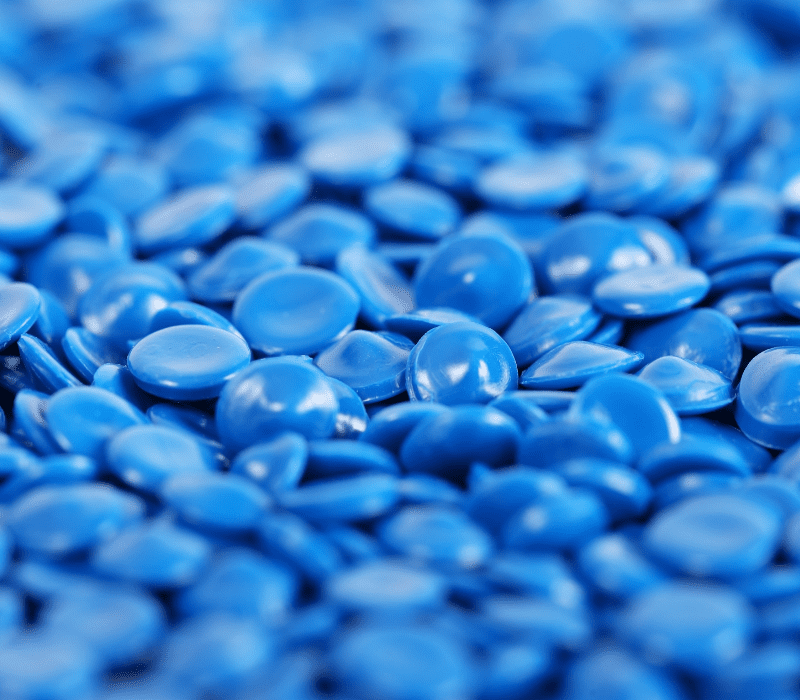 Blue plastic pellets used for manufacturing