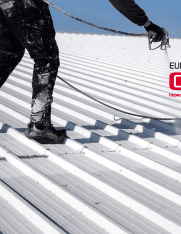 Person on roof spraying paint