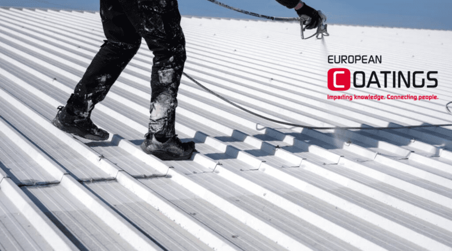 Person on roof spraying paint